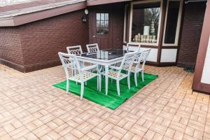 a white table and chairs on a patio at High-End Oasis Close to Fun in Homewood