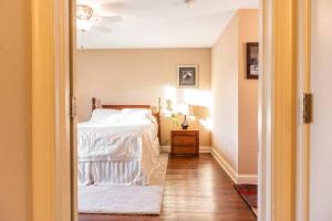 a bedroom with a bed with a white comforter at High-End Oasis Close to Fun in Homewood