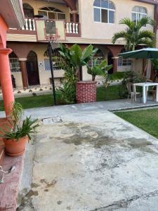 a patio in front of a house with a table at Hotel Posada Gutierrez in Panajachel