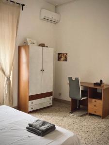 Un dormitorio con una cama, un escritorio y un armario. en Shared apartment in Catania center., en Catania