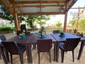 a black table and chairs under a pavilion at Port Barton - Paradiso Azul Campsite Beachfront with Internet in San Vicente +69 photos