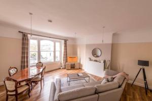 a living room with a couch and a table at Modern Cambridge Park with FREE PARKING by Prescott Apartments in Bristol