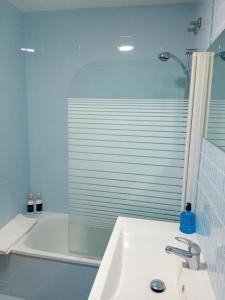 a bathroom with a sink and a shower and a tub at Apartamento Luna in Gandía +13 photos