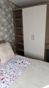 a bedroom with a bed and a book shelf at Floppyfeet Pet Friendly Holiday Home Rental Thornwick Bay, Flamborough in Flamborough