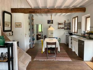 a kitchen with a table in the middle of a room at Cozy Catalan Cottage in Reynès