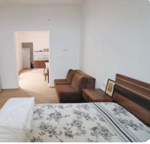 a bedroom with a bed and a living room with a couch at Aymena B in Kusadası