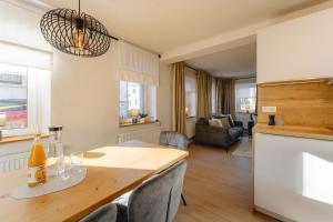 a kitchen and living room with a table and chairs at Berghaisl Neudorf in Neudorf