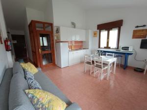 a living room with a couch and a table and a kitchen at Apartamentos la Escuela en Cantabria in Villegar