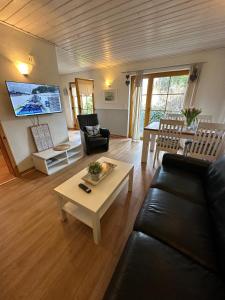 a living room with a couch and a table at Ferienhaus Leuchtturm in Fehmarn