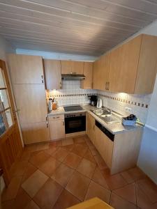 a small kitchen with a sink and a stove at Ferienhaus Leuchtturm in Fehmarn