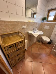a bathroom with a sink and a toilet at Ferienhaus Leuchtturm in Fehmarn +20 photos