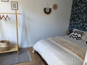a bedroom with a bed and a wall at Maison de charme in Ambleny