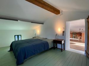 a bedroom with a bed and a table and a window at Cozy Catalan Cottage in Reynès +10 photos