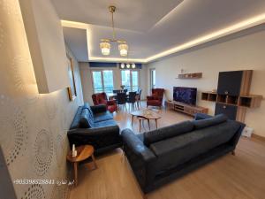 a living room with two couches and a dining room at تركيا . بورصا . منتجع بورصا مودرن in Bursa