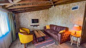 a living room with a couch and a table at Kazdağı Atila Bey Konağı in Ayvacık