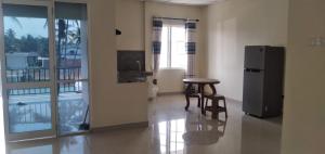 um quarto com um frigorífico, uma mesa e cadeiras em Saragama Apartment em Kurunegala