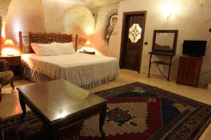 a hotel room with a bed and a coffee table at Ascension Cave Suites - Special Class in Göreme