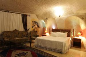 a bedroom with a bed and a horse on the wall at Ascension Cave Suites - Special Class in Göreme