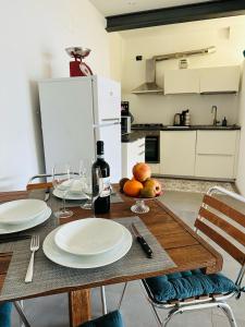 a kitchen with a table with plates and wine glasses at THERANCOBAY - lake view apartment - in Ranco