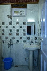 a bathroom with a sink and a mirror at Valley View rooms near Khajjiar Lake in Lāhri