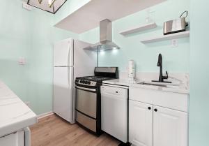 a kitchen with a stove and a refrigerator at Cabana Palms - Oceanfront Renovated King Bed Sauna in Myrtle Beach