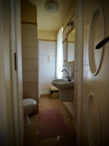 a small bathroom with a toilet and a sink at Villa Romano in Kielce