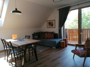 a living room with a table and a couch at Apartments Gorski raj in Kranjska Gora