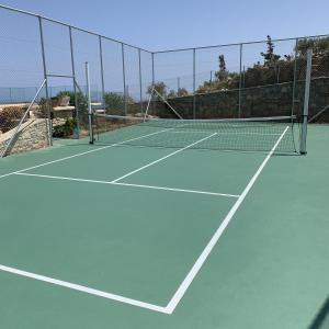a tennis court with a net on top of it at Sea Views at villa Anemomylos with Heated Pool, Ping Pong and Tennis in Agia Pelagia +50 photos