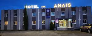 a hotel with a sign on the front of it at ANAIS HOTEL Bourges in Saint-Doulchard