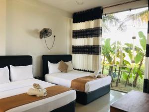 Postel nebo postele na pokoji v ubytování Rivonway Hotel Polonnaruwa
