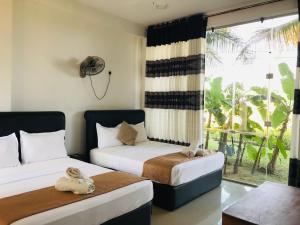 Ένα ή περισσότερα κρεβάτια σε δωμάτιο στο Rivonway Hotel Polonnaruwa
