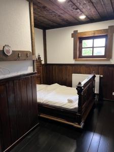 a bedroom with a large bed and a bath tub at Senasis Rambynas in Lumpėnai