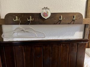a wooden dresser with a mirror on top of it at Senasis Rambynas in Lumpėnai
