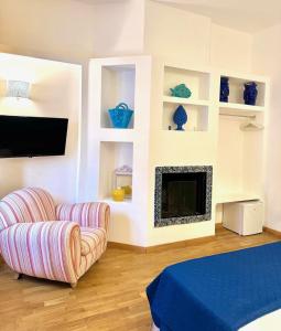 a living room with a couch and a fireplace at Qurchiti in Capo dʼOrlando