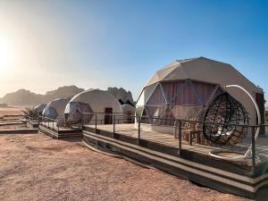 a row of domed tents in the desert at Hasan Zawaideh Camp in Wadi Rum