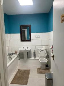 a bathroom with a white toilet and a sink at Private Room 1 Near Southmead Hospital, Bristol in Bristol