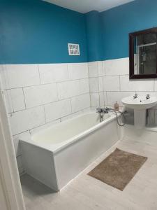 a bathroom with a white tub and a sink at Private Room 1 Near Southmead Hospital, Bristol in Bristol