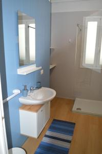 a bathroom with a white sink and a mirror at Mare a Sud in Villaggio Azzurro