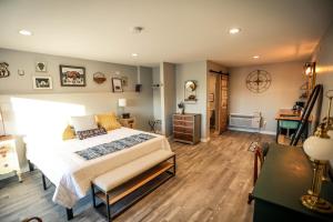 a bedroom with a large bed and a desk at The Blue Buffalo Motel in Douglas