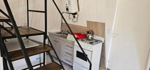 a small kitchen with a stove and a refrigerator at La Torre del Lago in Villa Meliquina +7 photos