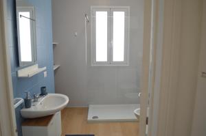 a bathroom with a sink and a toilet and a window at Mare a Sud in Villaggio Azzurro