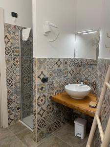 a bathroom with a sink and a shower at HOTEL rurale Essenza di Mirto in La Caletta