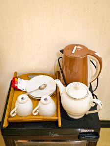 a tea pot and cups sitting on a table at Wild Horizon in Udawalawe