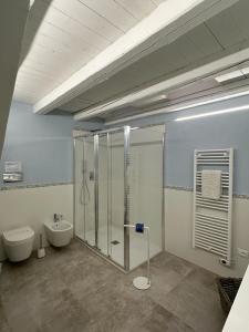 a bathroom with a shower and a toilet and a sink at Archè in Syracuse
