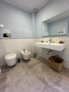 a bathroom with a sink and a toilet and a mirror at Archè in Syracuse