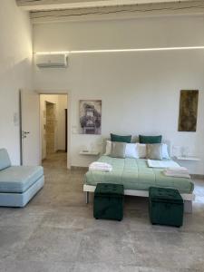 a living room with a bed and a couch at Archè in Syracuse