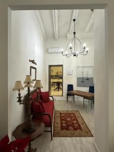 a living room with a red chair and a table at Archè in Syracuse