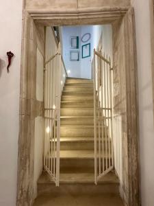 a staircase with wooden railings in a building at Archè in Syracuse