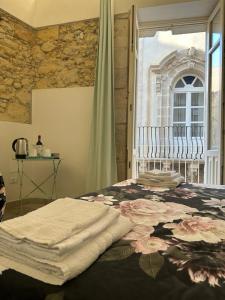 a bedroom with a bed and a window at Archè in Syracuse