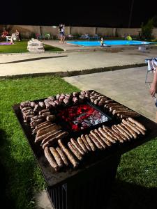 Een grill met hotdogs erop. bij Villa Perilli - Luxury Stay con piscina privata in Diso